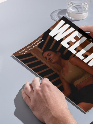 Person holding a Comprehensive Wellness Guide preparing to read