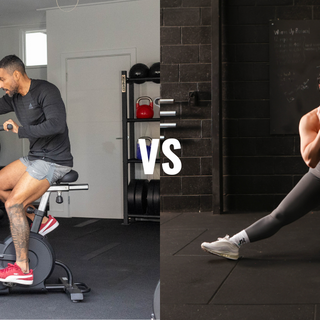 man on exercise bike and woman doing side lunge with dumbbell