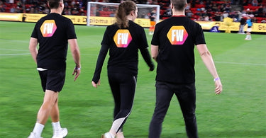 Fitness Warehouse Fastest Fan Competitors walking onto the soccer field