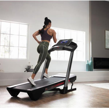 Woman using a treadmill at home
