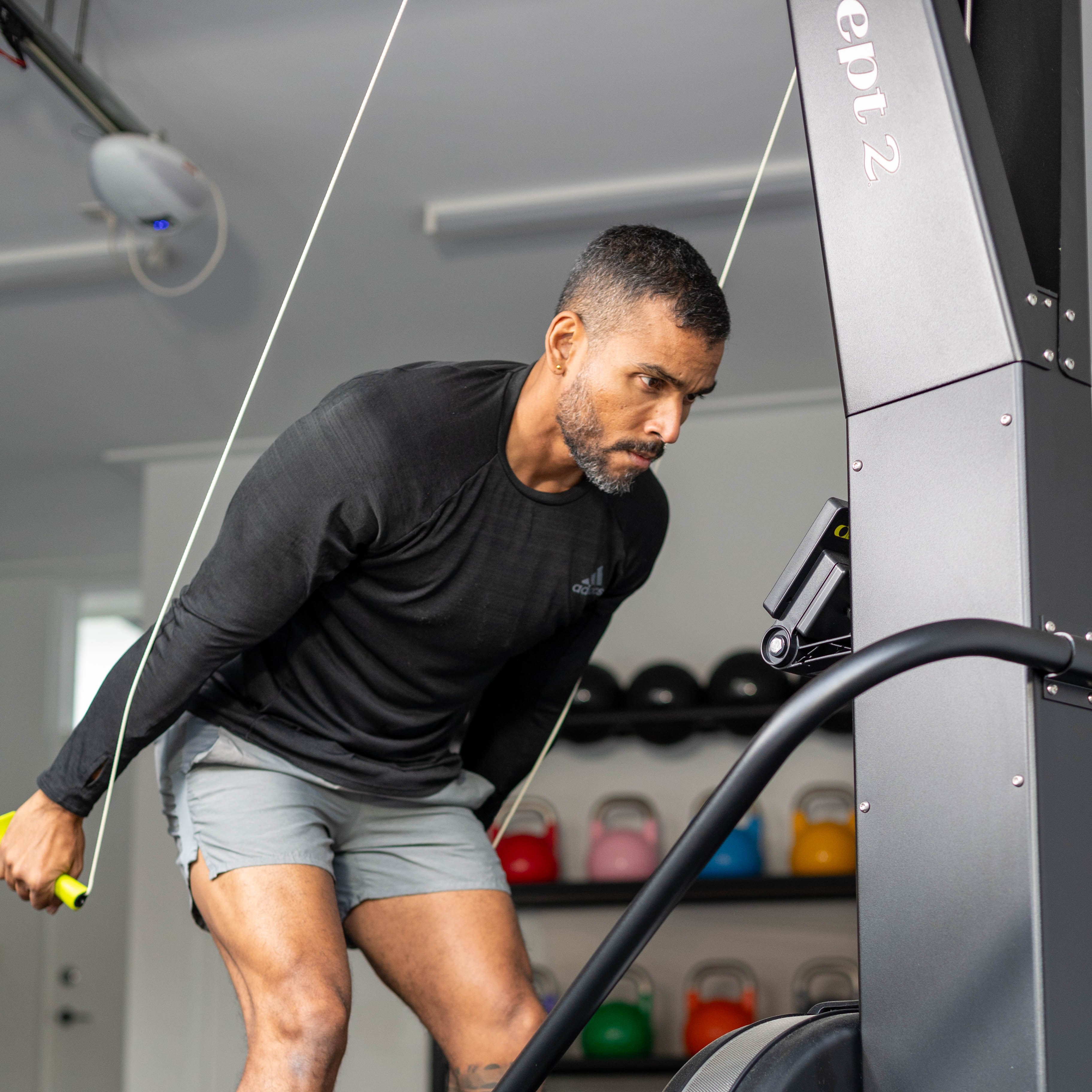 Man exercising on a piece of exercise equipment in a gym.