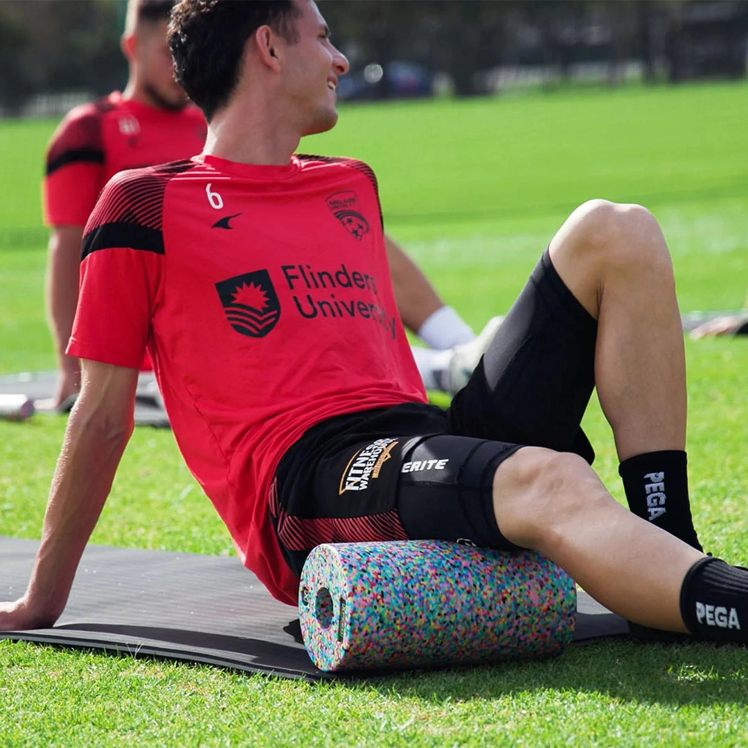 Adelaide United soccer team member using a Foam Roller