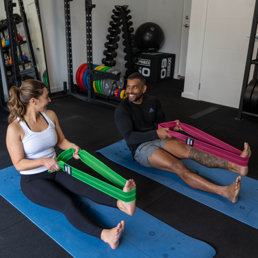 Two people working out with Xpeed bands