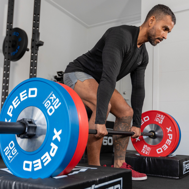 Man doing deadlifts in home gym