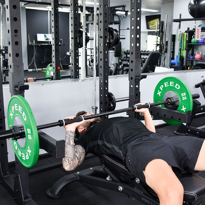 Men doing bench press using barbell 