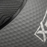Close-up of a dark gray textured athletic surface with a black curved trim and a partial white geometric logo.
