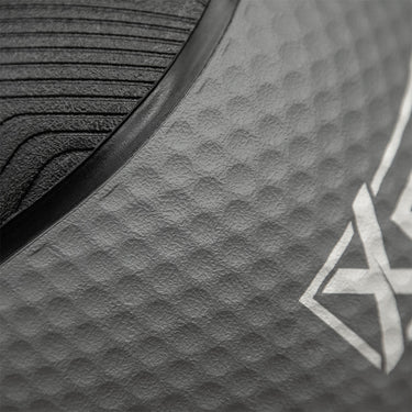 Close-up of a dark gray textured athletic surface with a black curved trim and a partial white geometric logo.