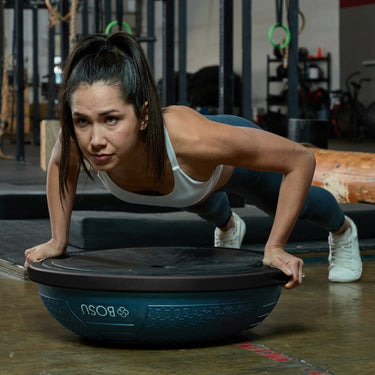 Female training with a Bosu Ball Home NEXGEN Balance Trainer