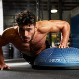 Male doing one handed push up on Bosu Ball Home NEXGEN Balance Trainer